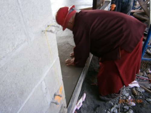 Lama Norlha Rinpoche Marking Fresh Concrete